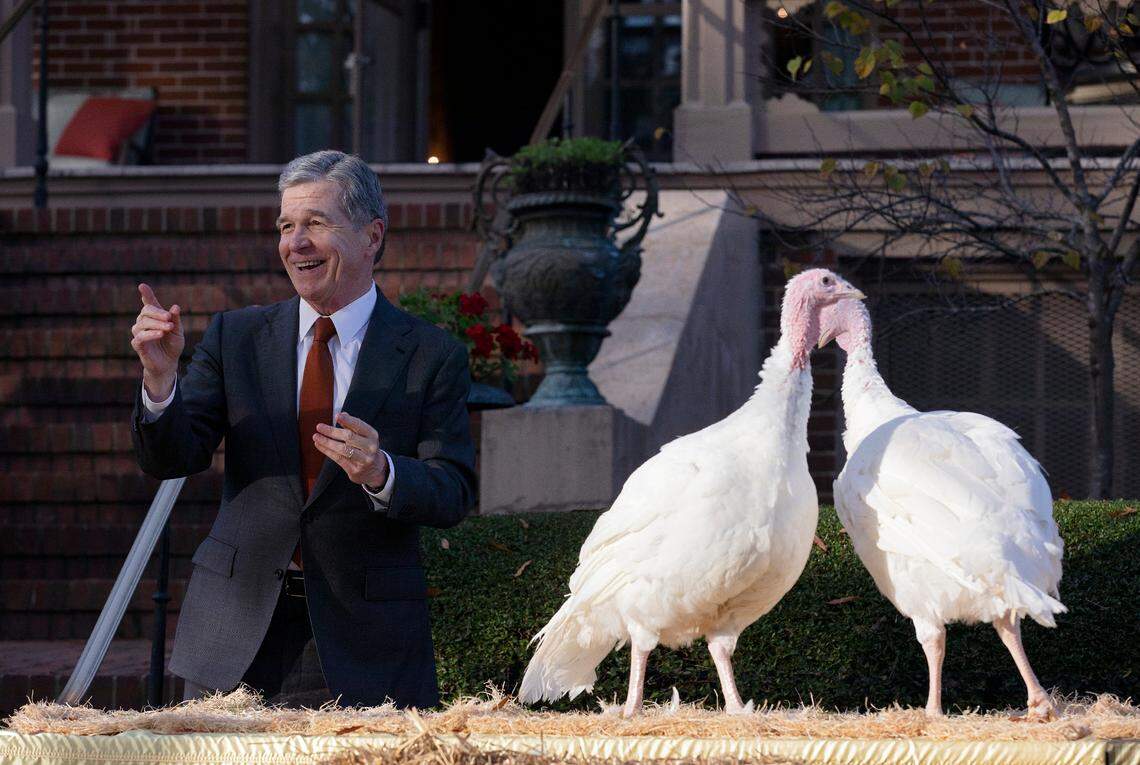 Gov. Roy Cooper smiles as he pardons two turkeys, Ethel and Bertha, in a ceremony at the North Carolina Executive Mansion on Monday, Nov. 25, 2024, in Raleigh, N.C.