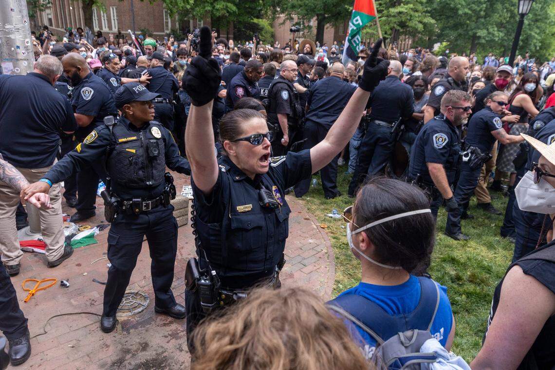 Pro-Palestinian demonstrators clash with police after replacing an American flag with a Palestinian flag Tuesday, April 30, 2024 at UNC-Chapel Hill. Police removed a “Gaza solidarity encampment” earlier Tuesday morning.
