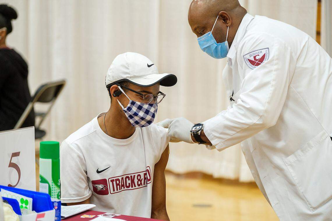 Jacob Irving, a junior at N.C. Central University, gets a COVID-19 vaccine shot from Steve Nwanguma, an alumnus of NCCU nursing program, at N.C. Central University in Durham, N.C. in March, 2021.