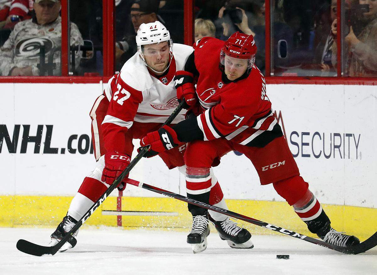Lucas Wallmark (71) and Michael Rasmussen (27) compete for the puck during the second period of an NHL hockey game Saturday, Nov. 10, 2018,