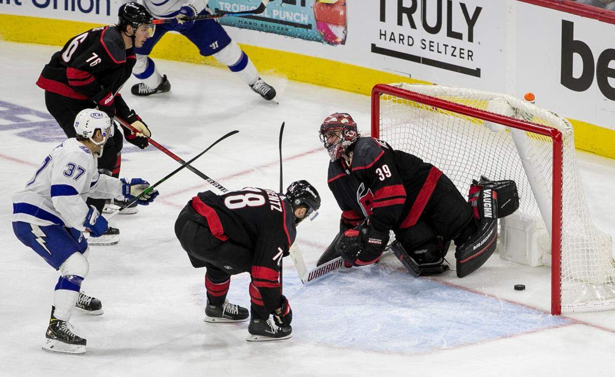Carolina Hurricanes goalie Alex Nedeljkovic (39) gives up a goal to Tampa Bay’s Barclay Goodrow (19) in the third period as Tampa Bay takes a 2-1 lead over the Hurricanes in game one of their second round Stanley Cup series on Sunday, May 30, 2021 at PNC Arena in Raleigh, N.C.