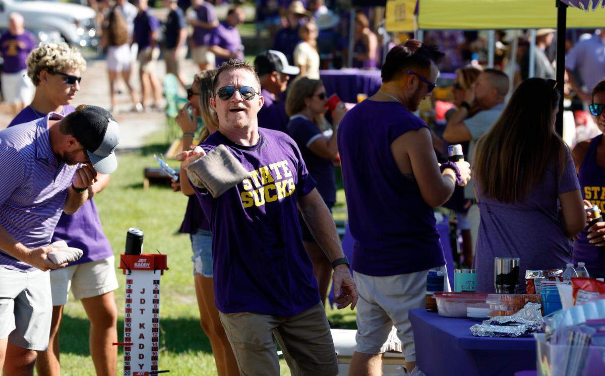 Gerald Logan of Greenville plays Cornhole while tailgating before N.C. States game against ECU at Dowdy-Ficklen Stadium in Greenville, N.C., Saturday, Sept. 3, 2022.