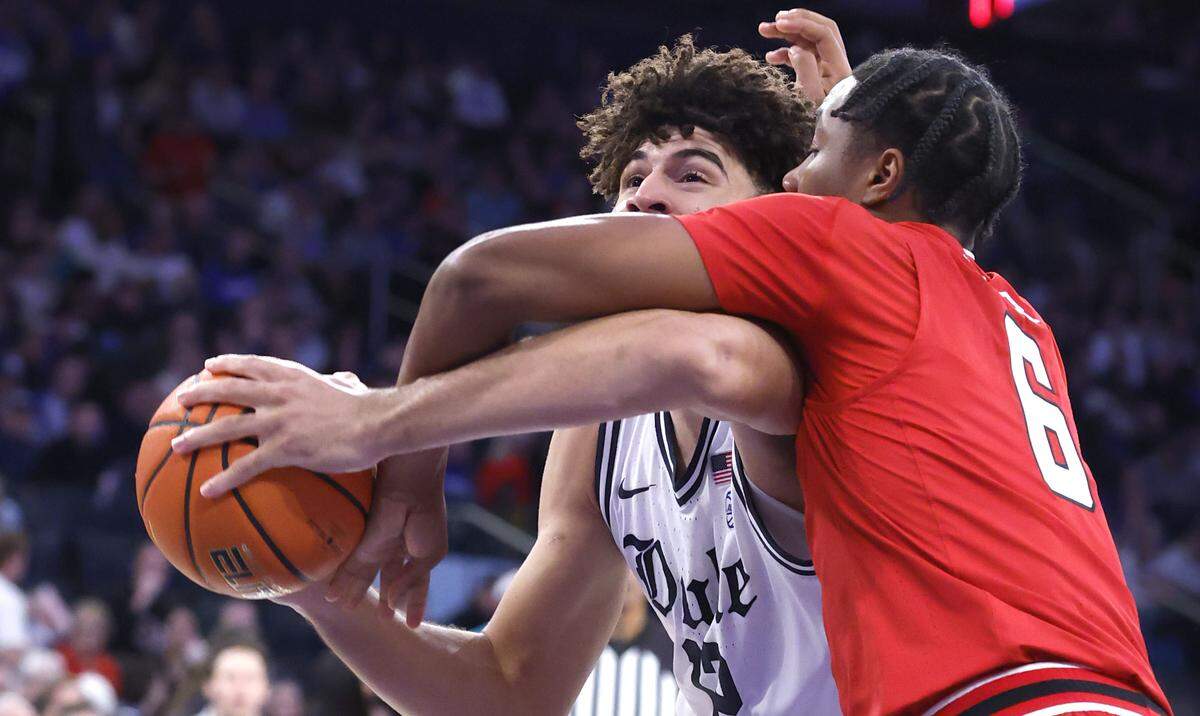 Duke’s Cameron Boozer (12) is fouled by Texas Tech's Leon Horner (6) during the second half of Texas Tech’s 82-81 victory over Duke in the SentinelOne Classic at Madison Square Garden in New York City, N.Y., Saturday, Dec. 20, 2025.