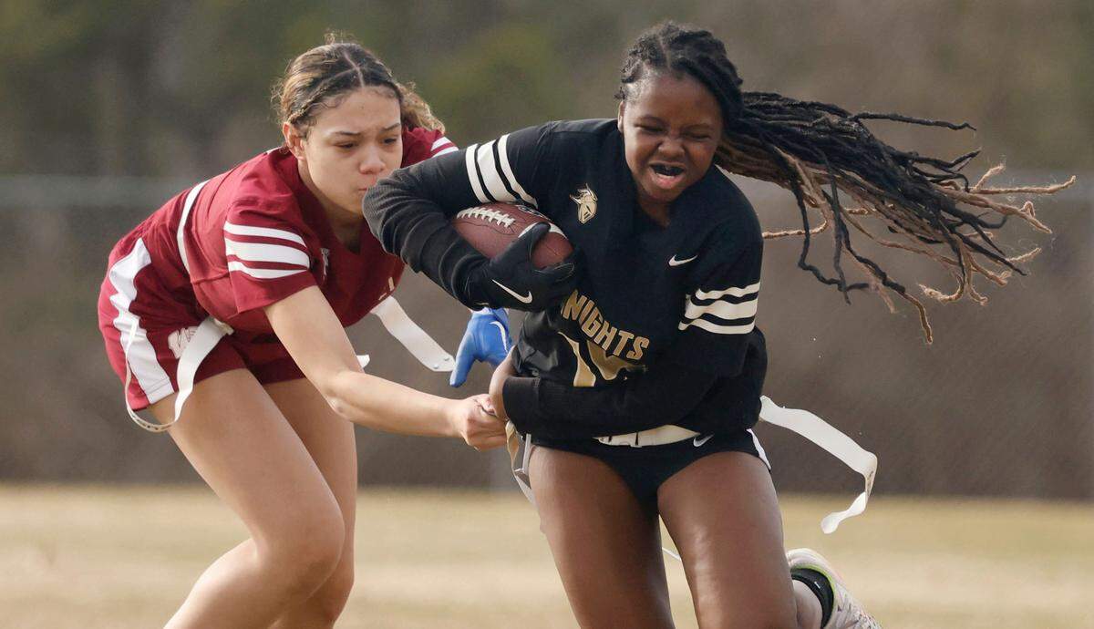 Knightdale High School’s Kimora Williams (15) tries to get by Wakefield High School’s Sydney Conti (7) during a flag football scrimmage at Heritage High School in Wake Forest, N.C., Wednesday, Jan. 24, 2024.