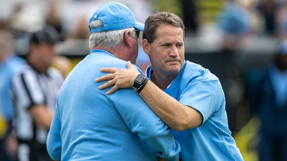 North Carolina defensive coach Gene Chizik embraces head coach Mack Brown prior to the Tar Heels game against Appalachian State on Saturday, September 3, 2022 at Kidd Brewer Stadium in Boone, N.C.