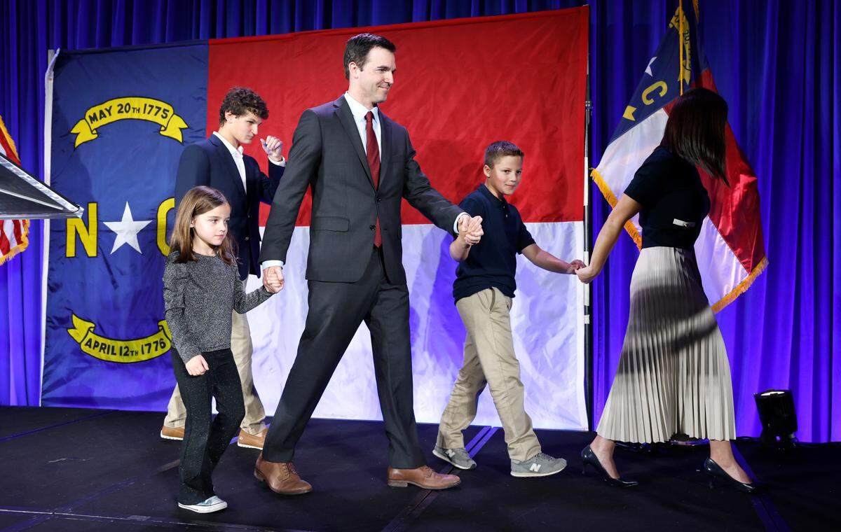 Attorney General-elect Jeff Jackson walks off the stage with his family, from left, Haden, Avery, Owen and his wife Marisa after addressing the crowd during a North Carolina Democratic Party election night event at the Marriott City Center in Raleigh, N.C., Tuesday, Nov. 5, 2024.
