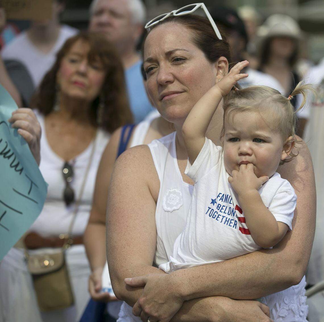 Sarah Stoeckel of Cary, holds her fifteen-month-old daughter Brooke Stoeckel during the 'Families Belong Together' march and rally on Saturday, June 30, 2018 in Raleigh, N.C.