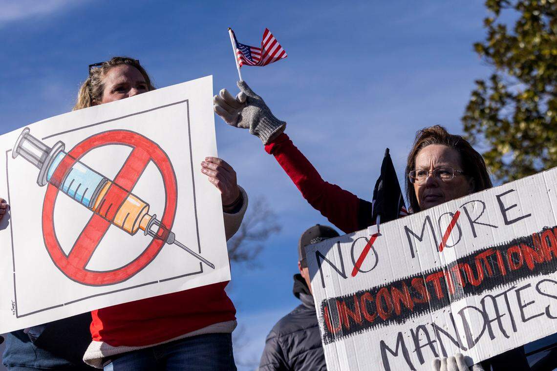 Demonstrators opposed to vaccine requirements protest outside the The N.C. Commission for Public Health in Raleigh Wednesday, Feb. 2, 2022. The commission unanimously voted against a rule-making petition from four UNC System professors to add the COVID vaccine to state immunization requirements for people who are 17 years old or who are entering 12th grade as of July 1.
