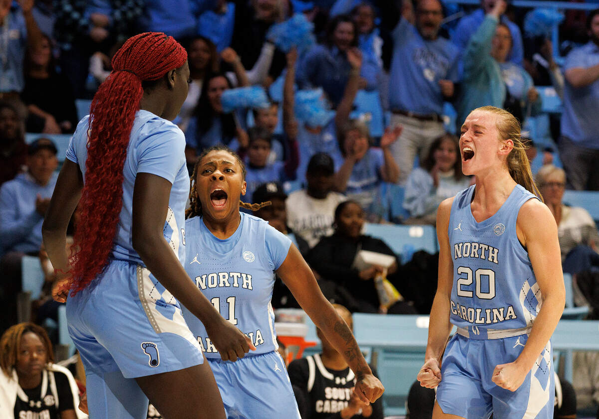 North Carolina’s Kayla McPherson (11) and Lexi Donarski (20) react after teammate Maria Gakdeng, left, was fouled during the first half of the Tar Heels’ game against South Carolina on Thursday, Nov. 30, 2023, at Carmichael Arena in Chapel Hill, N.C.