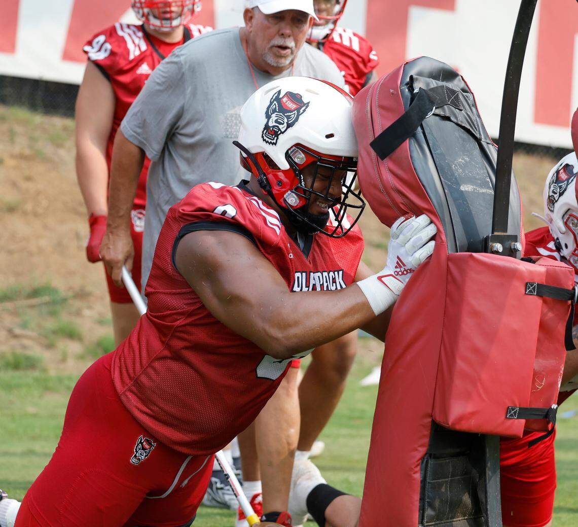 N.C. State defensive end Savion Jackson (9) hits the pads during the Wolfpack’s first fall practice in Raleigh, N.C., Wednesday, August 2, 2023.