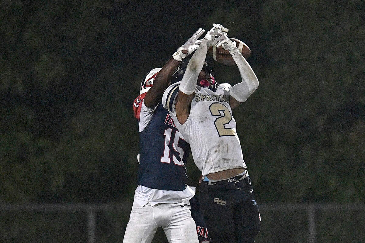 Jordan cornerback Lareun Wilson (15) defends the pass against Smithfield-Selma wide receiver Jamie Groves (2) during the first half. The Durham Jordan Falcons and the Smithfield-Selma Spartans met in a football game in Durham, N.C. on September 13, 2024.