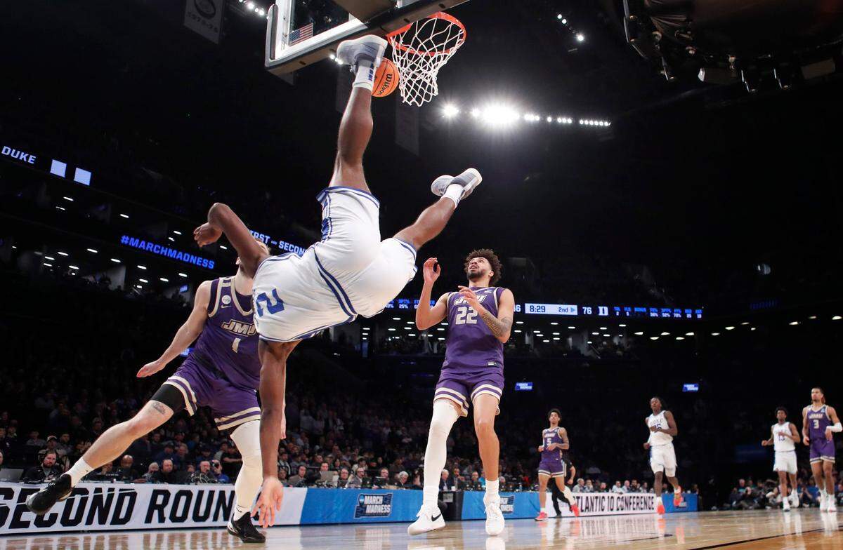 Duke’s Jaylen Blakes (2) goes down hard after being fouled by James Madison’s Noah Freidel (1) in the second half of Duke’s 93-55 victory over James Madison in the second round of the NCAA Tournament at the Barclays Center in Brooklyn, N.Y., Sunday, March 24, 2024.