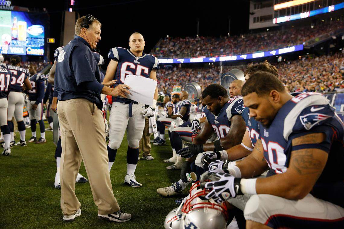 New England Patriots head coach Bill Belichick talks to his players on the sideline as they take on the New York Giants at Gillette Stadium in August 2013.