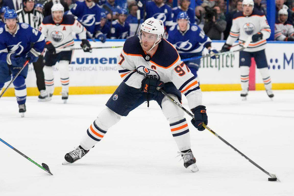 Edmonton Oilers center Connor McDavid (97) works against the Tampa Bay Lightning during the third period of an NHL hockey game Wednesday, Feb. 23, 2022, in Tampa, Fla. (AP Photo/Chris O’Meara)
