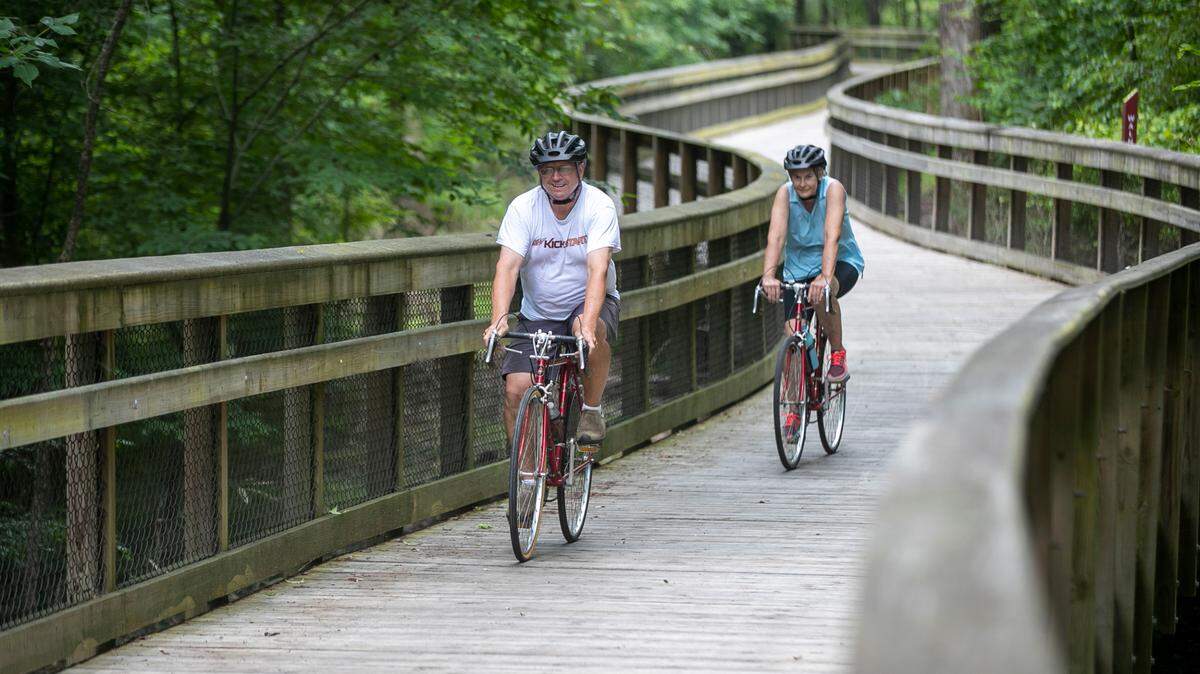 David Crouse and his wife Mary Crouse cycle the Walnut Creek Trail, part of the East Coast Greenway, on Tuesday, June 15, 2021, in Raleigh, N.C. Legislation approved Monday would add the East Coast Greenway to the North Carolina state parks system.