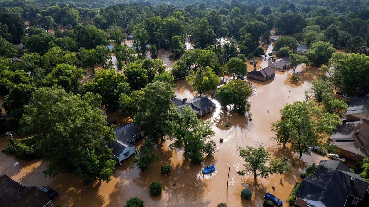 A water rescue unit paddles a raft in the Old Farm neighborhood along the Eno River in Durham on Monday morning, July 7, 2025, after Tropical Storm Chantal caused flash flooding.