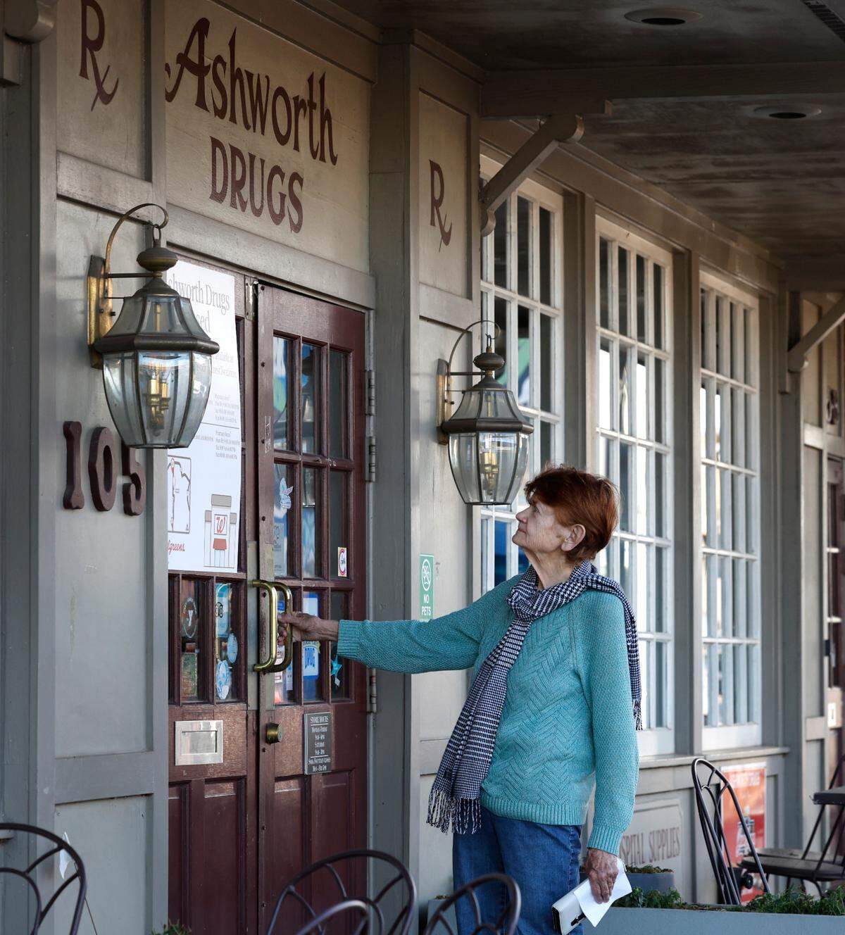 Gail Anderson tries to enter Ashworth Drugs in downtown Cary Thursday, Feb. 8, 2024. Anderson did not know that the store on West Chatham Street closed its doors.