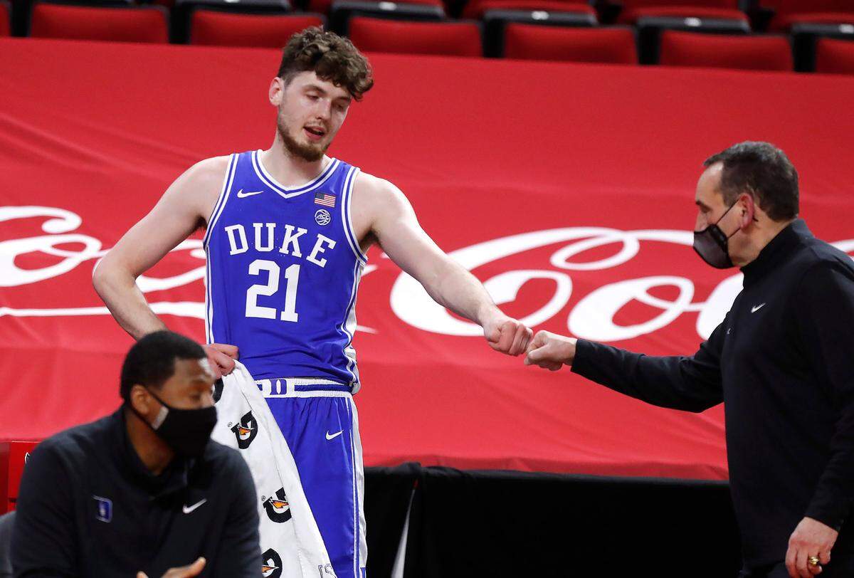 Duke’s Matthew Hurt (21) fist bumps head coach Mike Krzyzewski during the second half of Duke’s 69-53 victory over N.C. State at PNC Arena in Raleigh, N.C., Saturday, February 13, 2021.