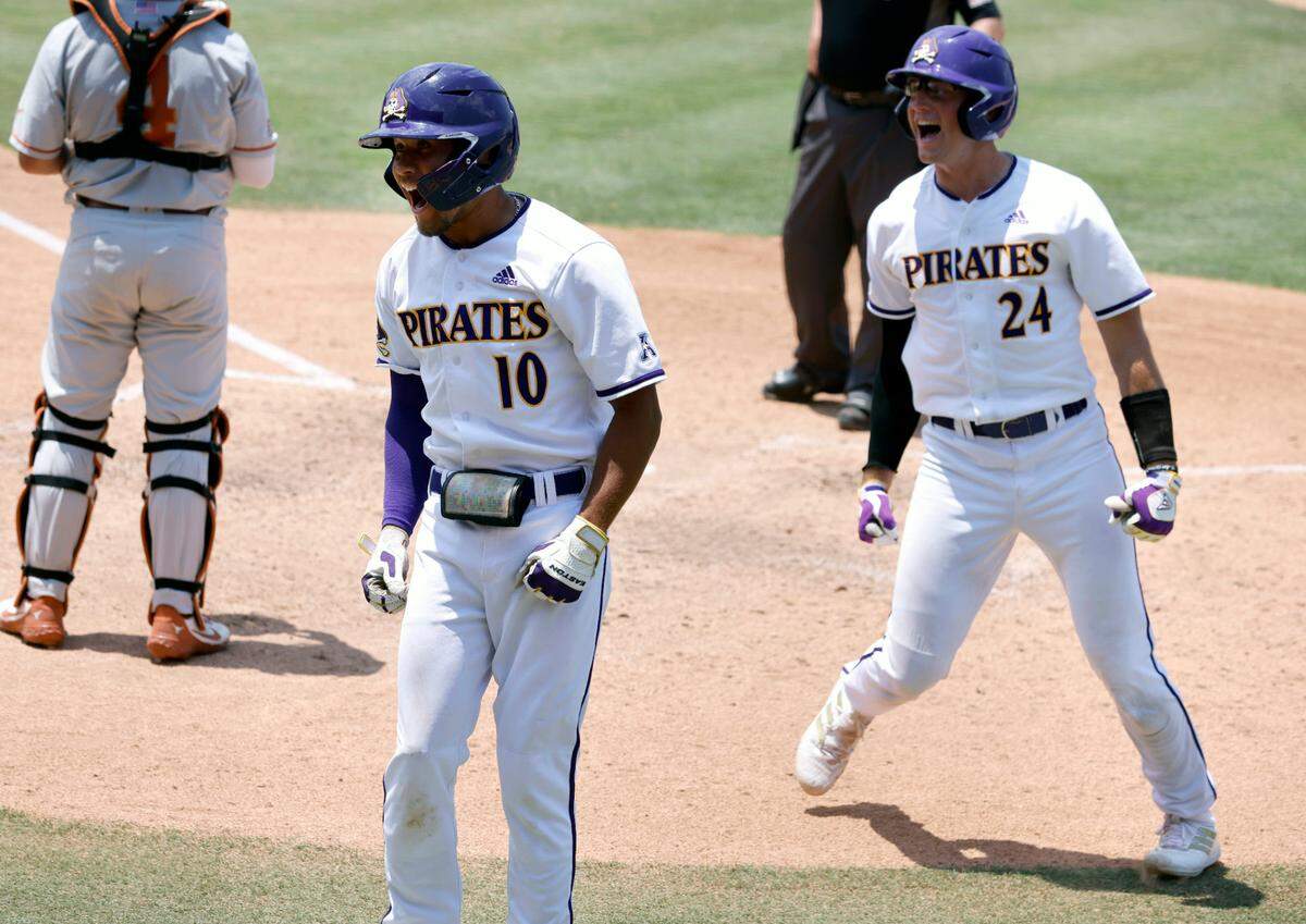 East Carolina’s Jacob Starling (10) celebrates with Ben Newton (24) after they both scored on a two-run homerun by Starling in the bottom of the fourth during ECUís game against Texas in the Greenville Super Regional at Clark-LeClair Stadium Friday, June 10, 2022.