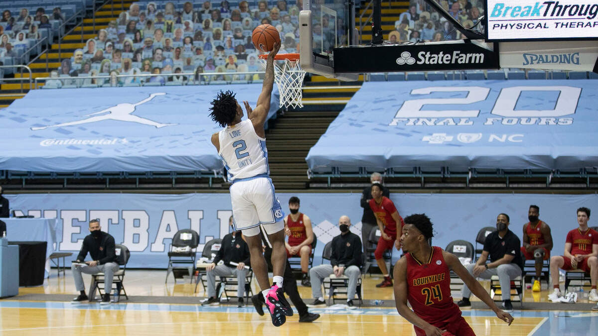 North Carolina’s Caleb Love (2) scores on a fast break after making a steal during the half against Louisville on Saturday, February 20, 2021 at the Smith Center in Chapel Hill, N.C.