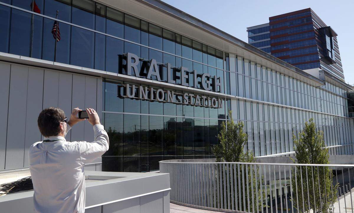 David Stutts with the N.C. Dept. of Transportation takes a picture of the building as the new Raleigh Union Station has its grand opening downtown on Monday, April 30, 2018.  