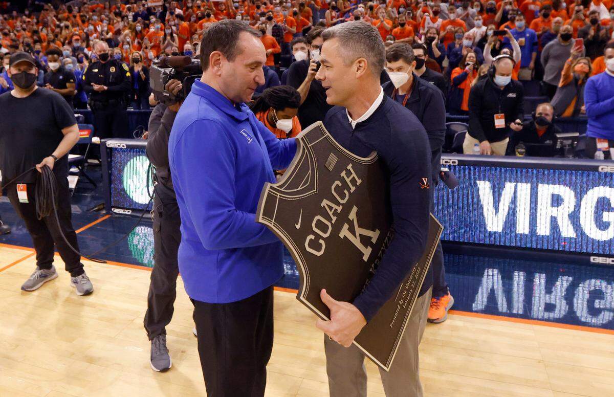 Duke head coach Mike Krzyzewski gets a plaque from Virginia head coach Tony Bennett before Duke’s game against Virginia at John Paul Jones Arena in Charlottesville, VA, Wednesday, Feb. 23, 2022.