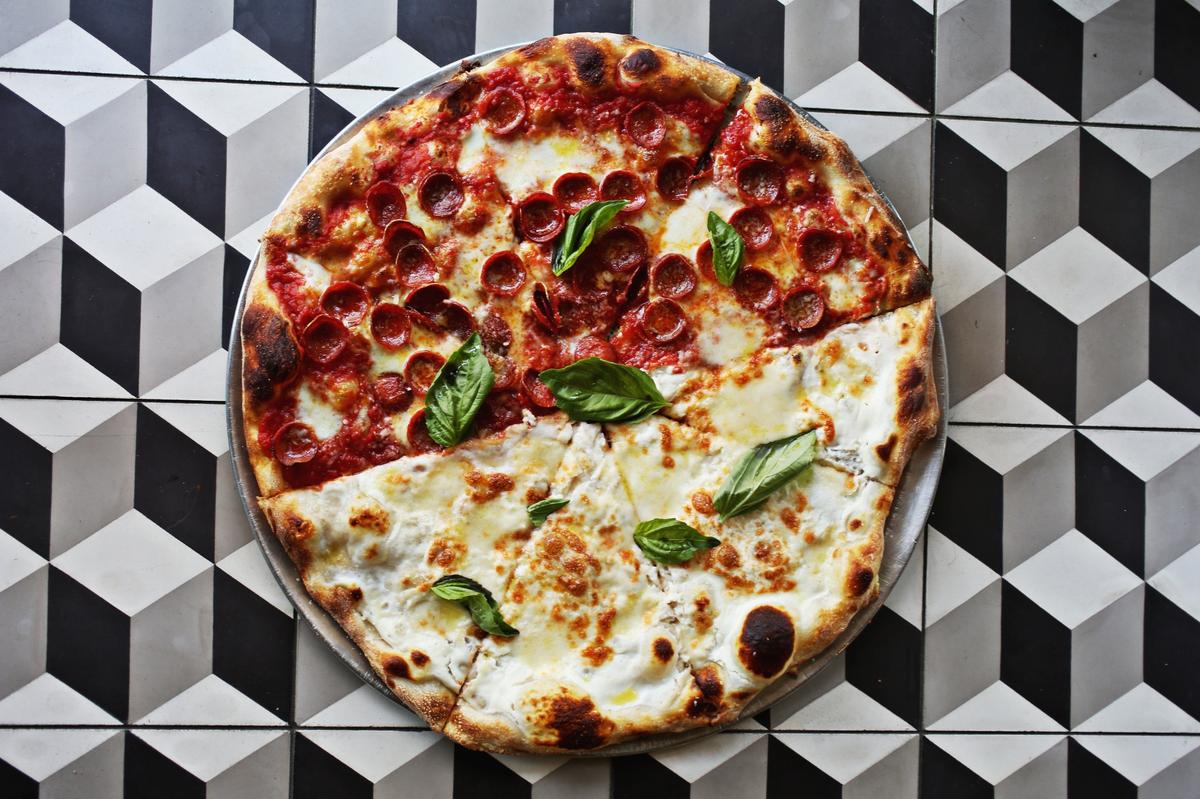 The 50/50 pie shown here is half pepperoni and white pizza at Oakwood Pizza Box in downtown Raleigh.