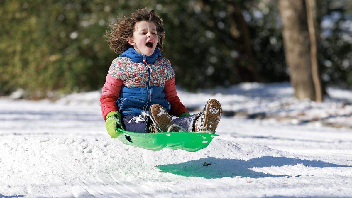 Margot Chappel sleds down Demerius Street on Sunday, Feb. 1, 2026, in Durham, N.C.