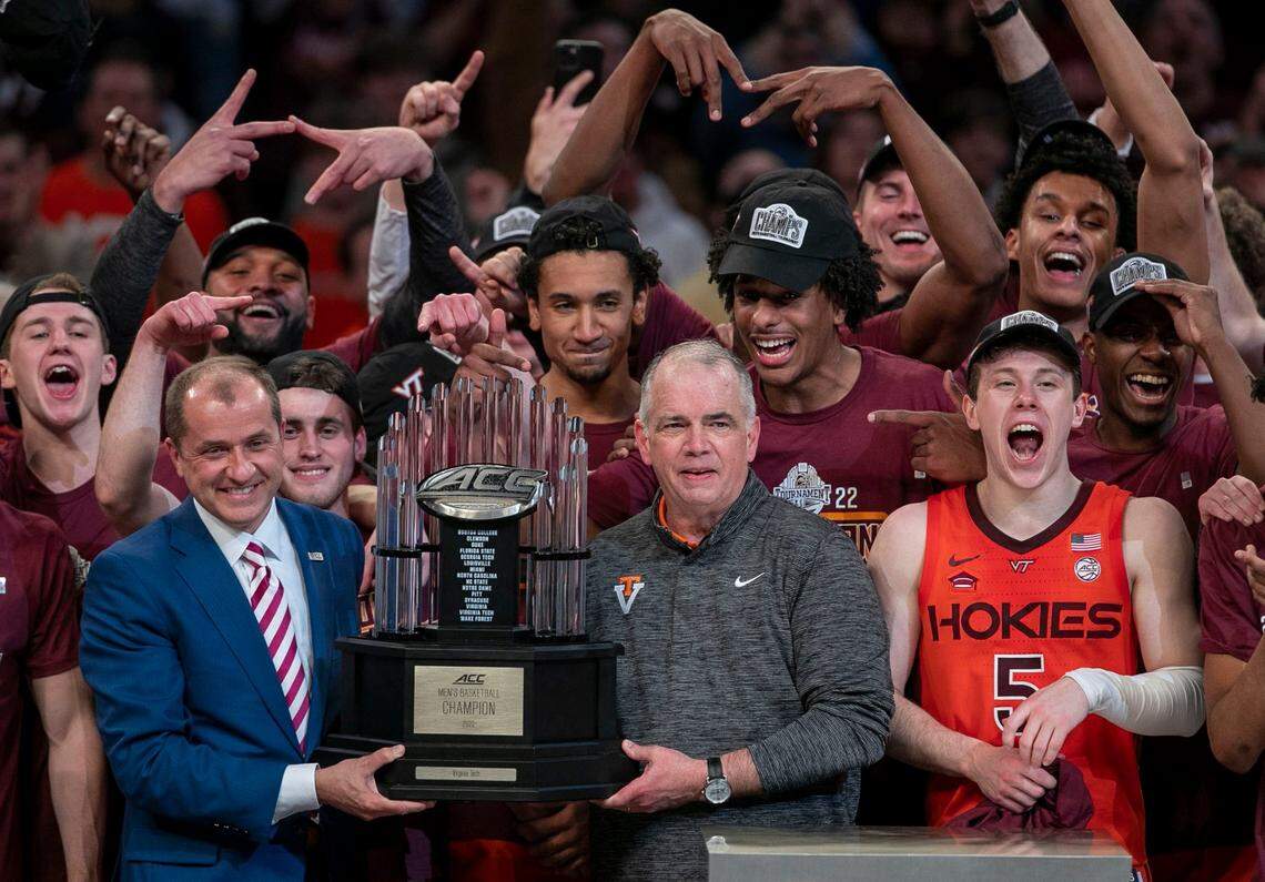 ACC Commissioner Jim Phillips presents the ACC Tournament Championship trophy to Virginia Tech coach Mike Young after the Hokies defeated Duke on Saturday, March 12, 2022 at Barclays Center in Brooklyn, N.Y.