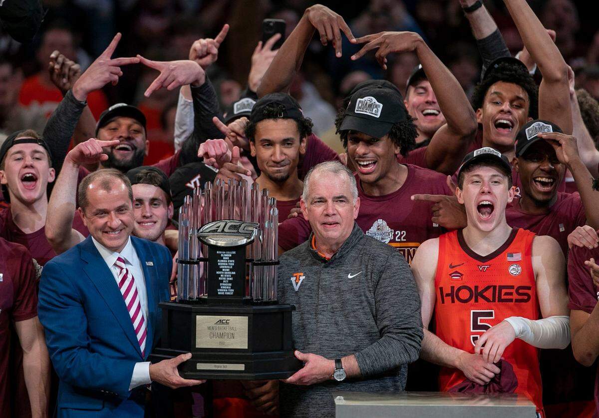 ACC Commissioner Jim Phillips presents the ACC Tournament Championship trophy to Virginia Tech coach Mike Young after the Hokies defeated Duke on Saturday, March 12, 2022 at Barclays Center in Brooklyn, N.Y.