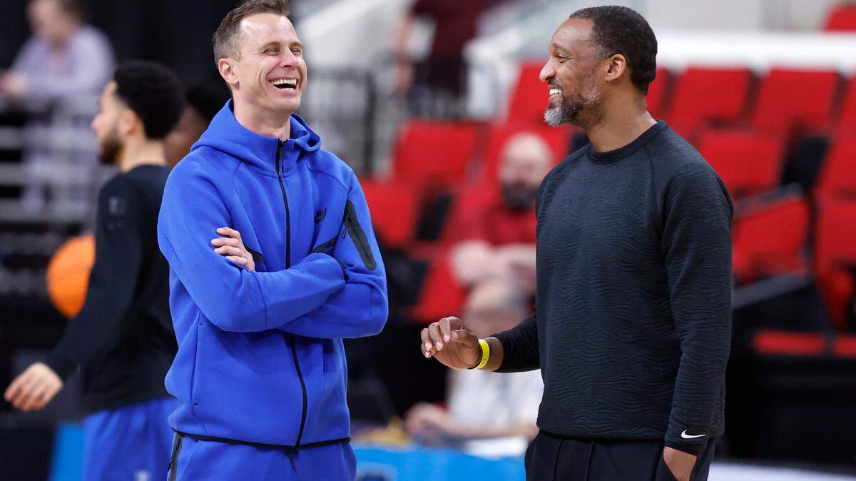 Duke head coach Jon Scheyer laughs with associate head coach Chris Carrawell during Duke’s open practice at the Lenovo Center in Raleigh, N.C., Thursday, March 20, 2025.