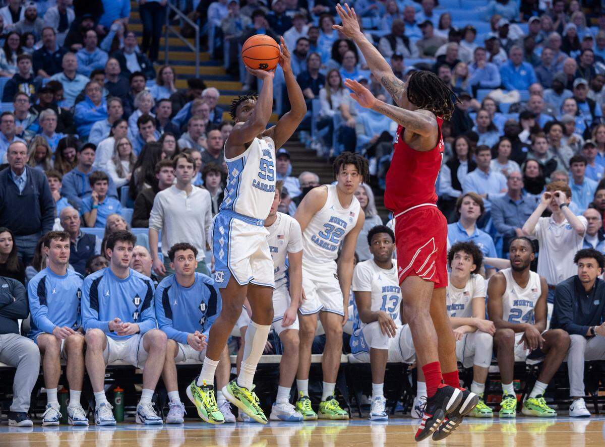North Carolina’s Harrison Ingram (55) launches a three point shot against Louisville’s Kaleb Glenn (10) in the second half on Wednesday, January 17, 2024 at the Smith Center in. Chapel Hill, N.C.