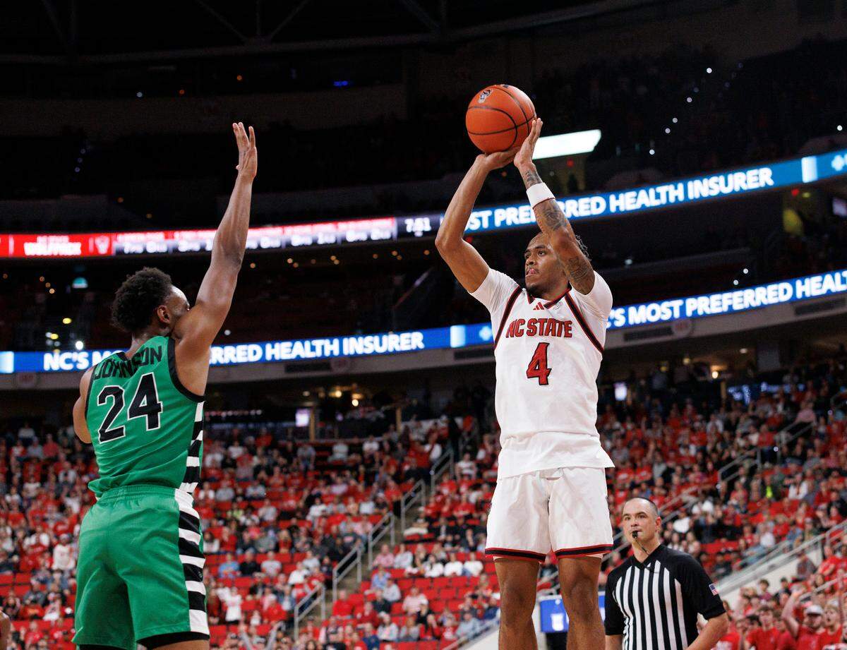 N.C. State’s Breon Pass shoots over USC Upstate’s Chico Johnson during the first half of the Wolfpack’s 97-66 win on Monday, Nov. 4, 2024, at Lenovo Center in Raleigh, N.C.