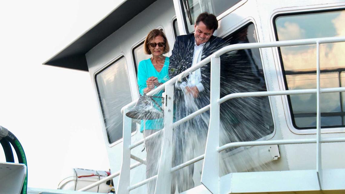 Brooke Burr, wife of U.S. Sen. Richard Burr, and Jordan Hennessy, christen the Miss Katie dredge at a Dare County ceremony Oct. 13, 2022.