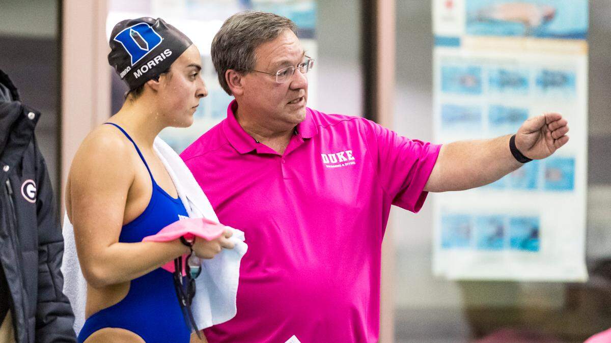 Duke swimming and diving coach Dan Colella instructs Blue Devils swimmer Halle Morris during a 2019 meet with Georgia at Duke’s Taishoff Aquatic Pavilion.