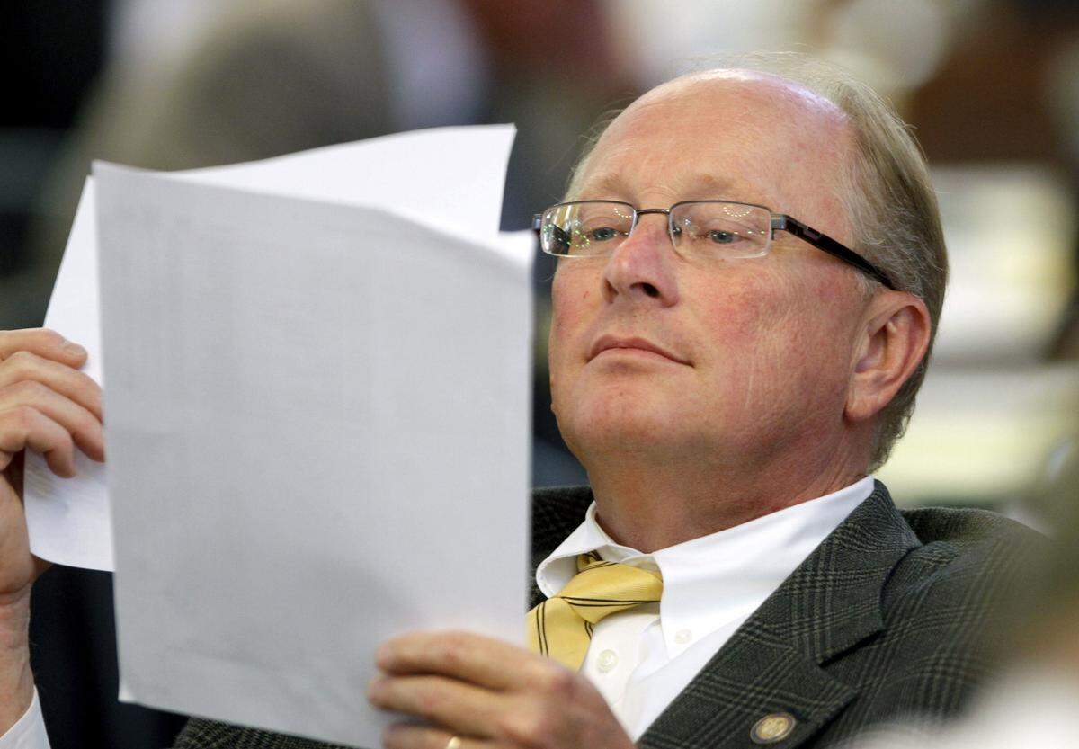 A 2012 photo shows then-Republican Rep. Mitch Gillespie reading amendments to a bill on the floor of the House.