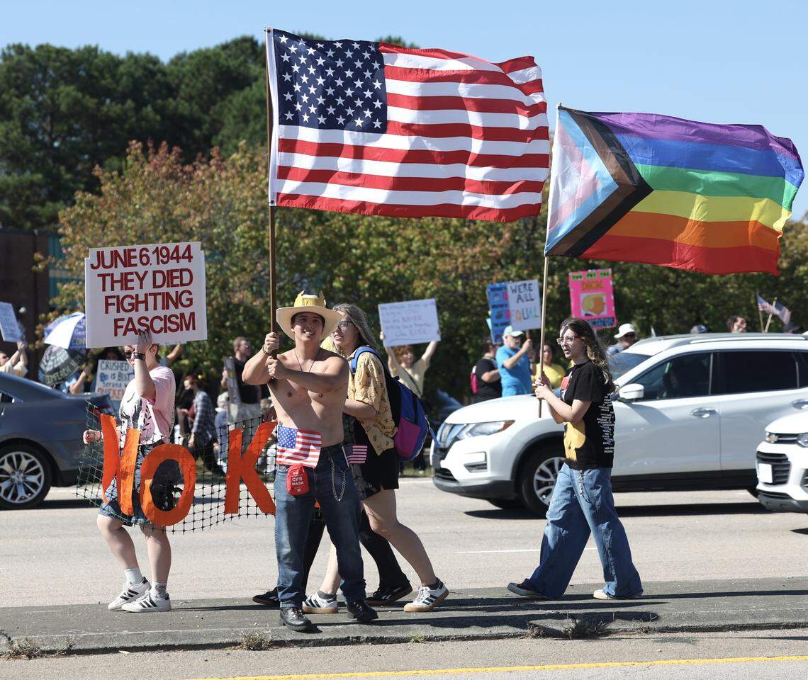 No Kings protester Pierce Winston from Clayton waves the U.S. flag in the median of Capital Blvd. in Raleigh, Saturday, Oct. 18, 2025.