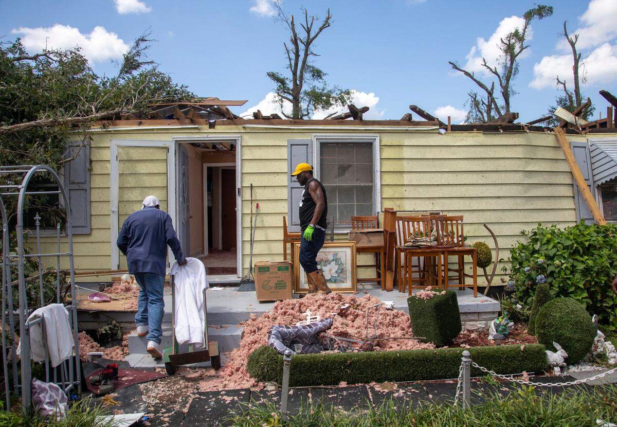 Family members help clean up the home of Evelyn Powell, an Edgecombe County Commissioner, Thursday, July 20, 2023 in Battleboro. An EF3, tornado with wind speeds of 150 mph touched down in Nash and Edgecombe Counties around 12:30 p.m. Wednesday according to the Raleigh National Weather Service.