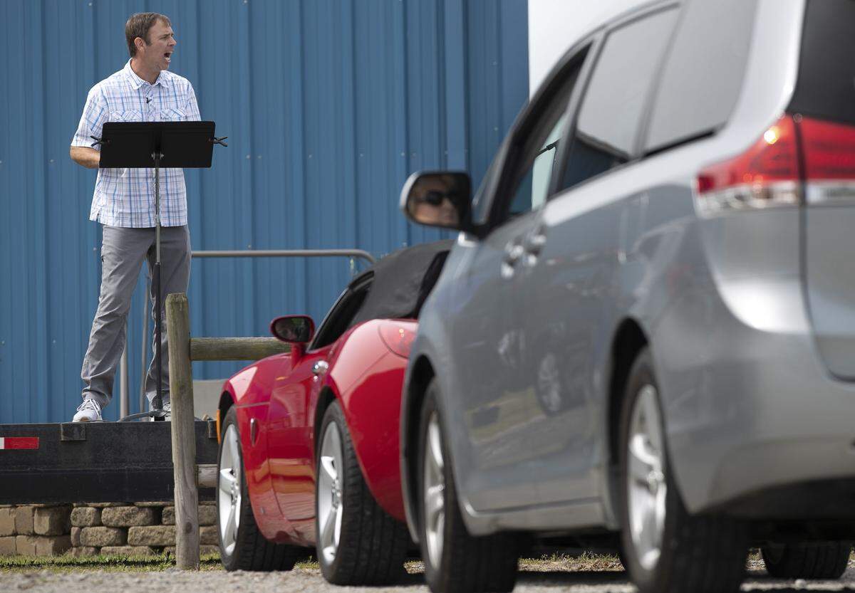 LifePoint Community Church pastor Nathan Redinger delivers his sermon during a drive-in worship service on Sunday, April 19, 2020 in Willow Spring, N.C.