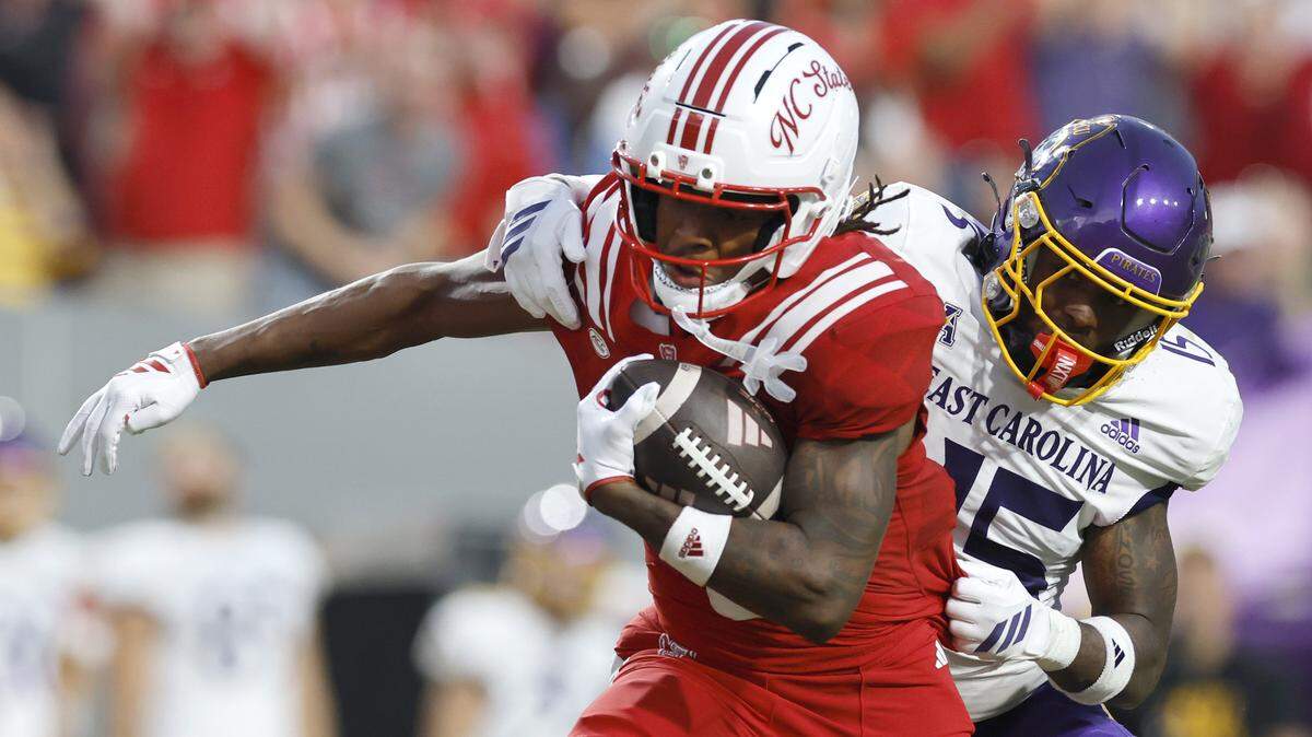 N.C. State wide receiver Wesley Grimes (6) breaks away from East Carolina defensive back Jordy Lowery (15) to score on a 48-yard touchdown reception during the first half of N.C. State’s game against ECU at Carter-Finley Stadium in Raleigh, N.C., Thursday, August 28, 2025.