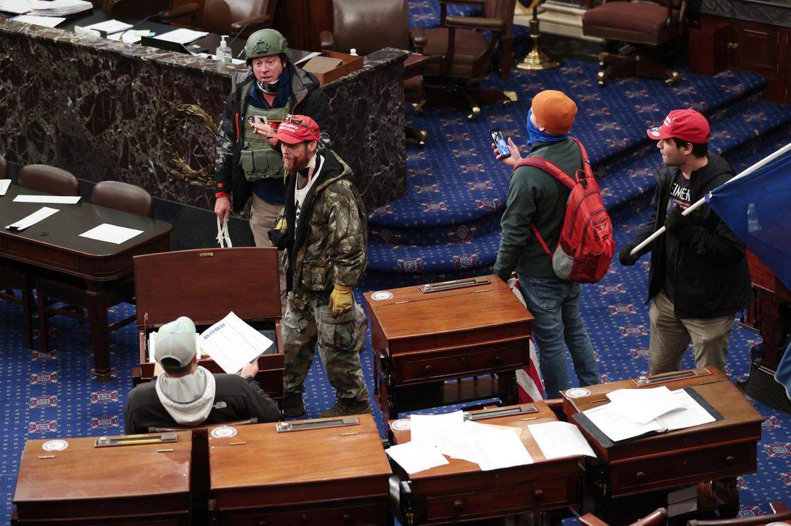 Rioters enter the Senate Chamber on Wednesday, Jan. 6, 2021 in Washington, D.C. Congress held a joint session today to ratify President-elect Joe Biden’s 306-232 Electoral College win over President Donald Trump. A group of Republican senators said they would reject the Electoral College votes of several states unless Congress appointed a commission to audit the election results.