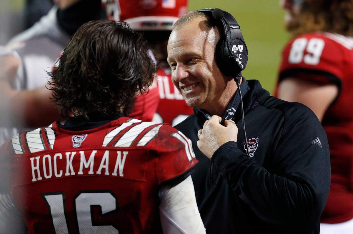 N.C. State head coach Dave Doeren talks with quarterback Bailey Hockman (16) during the second half of N.C. State’s 15-14 victory over Liberty at Carter-Finley Stadium in Raleigh, N.C., Saturday, Nov. 21, 2020.