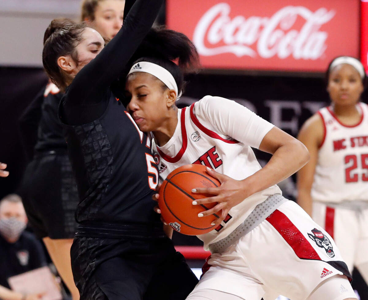 N.C. State’s Jakia Brown-Turner (11) is called for charging into Virginia Tech’s Georgia Amoore (5) during the second half of N.C. State’s 89-87 victory over Virginia Tech at Reynolds Coliseum in Raleigh, N.C., Sunday, January 24, 2021.