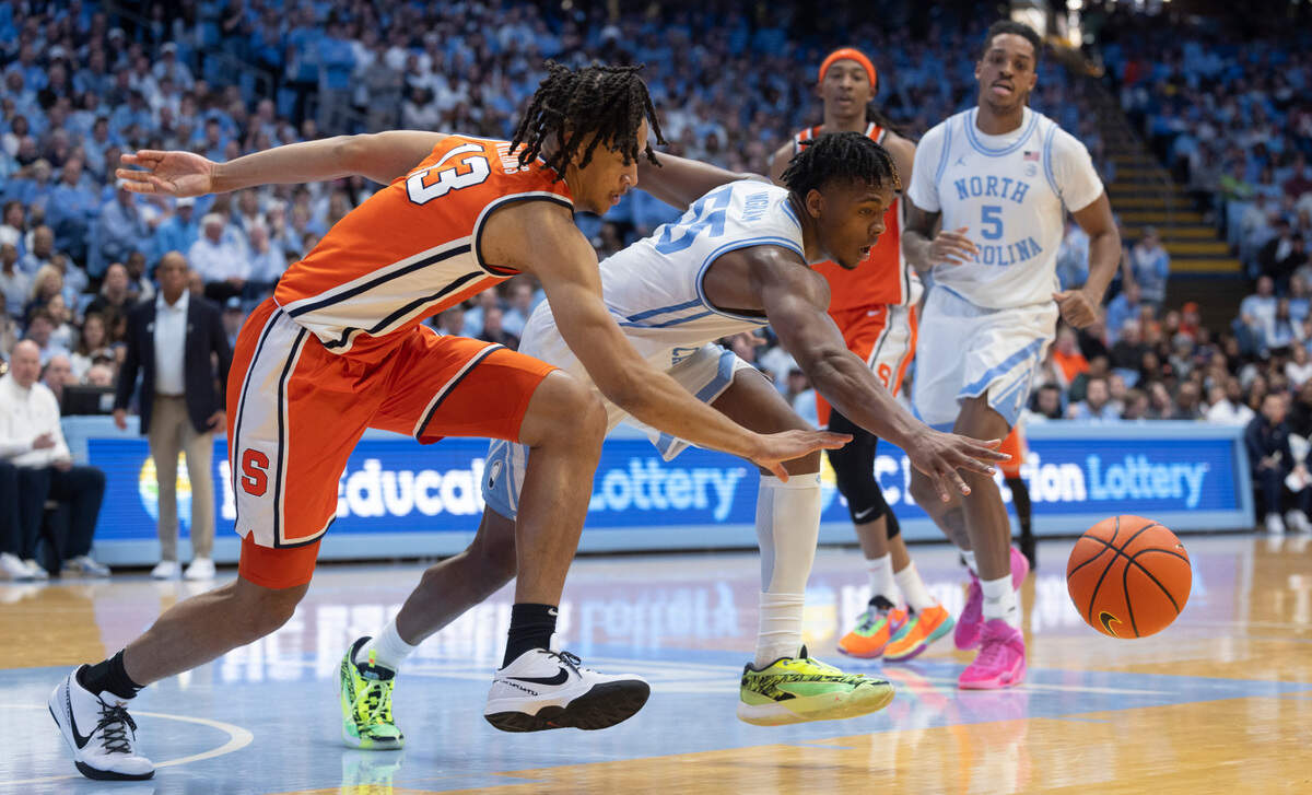 North Carolina’s Harrison Ingram (55) chases down a loose ball with Syracuse’s Benny Williams (13) in the second half on Saturday, January 13, 204 at the Smith Center in Chapel Hill, N.C