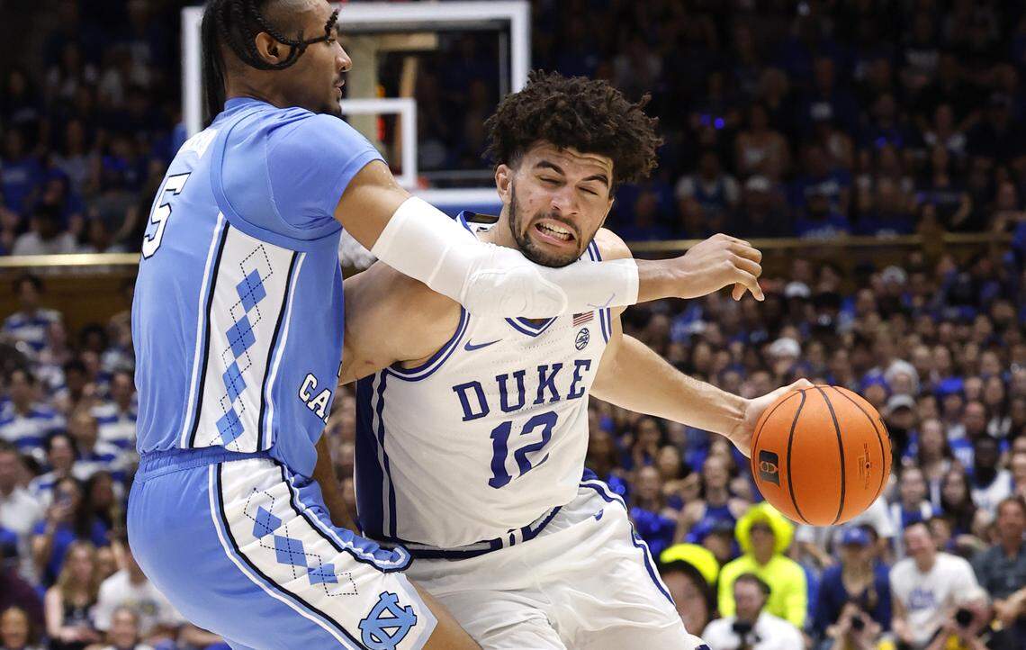 Duke’s Cameron Boozer (12) drives around North Carolina's Jarin Stevenson (15) during the second half of Duke’s 76-61 victory over UNC at Cameron Indoor Stadium in Durham, N.C., Saturday, March 7, 2026.