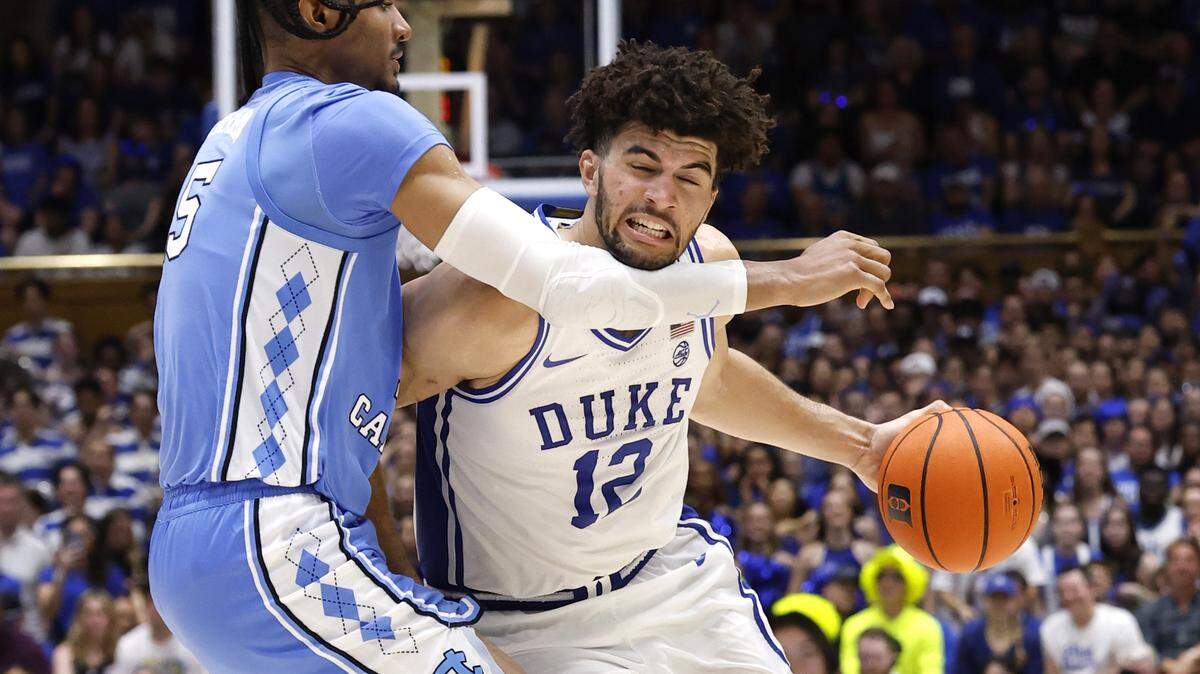 Duke’s Cameron Boozer (12) drives around North Carolina's Jarin Stevenson (15) during the second half of Duke’s 76-61 victory over UNC at Cameron Indoor Stadium in Durham, N.C., Saturday, March 7, 2026.