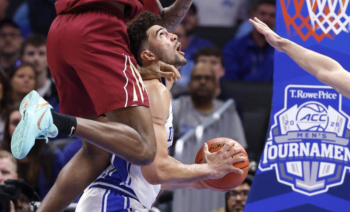 Duke’s Cameron Boozer (12) looks for room while defended by Florida State's Chauncey Wiggins (7) and Lajae Jones (10) during the first half of Duke’s game against Florida State in the quarterfinals of the 2026 ACC Men’s Basketball Tournament at the Spectrum Center in Charlotte, N.C., Thursday, March 12, 2026.