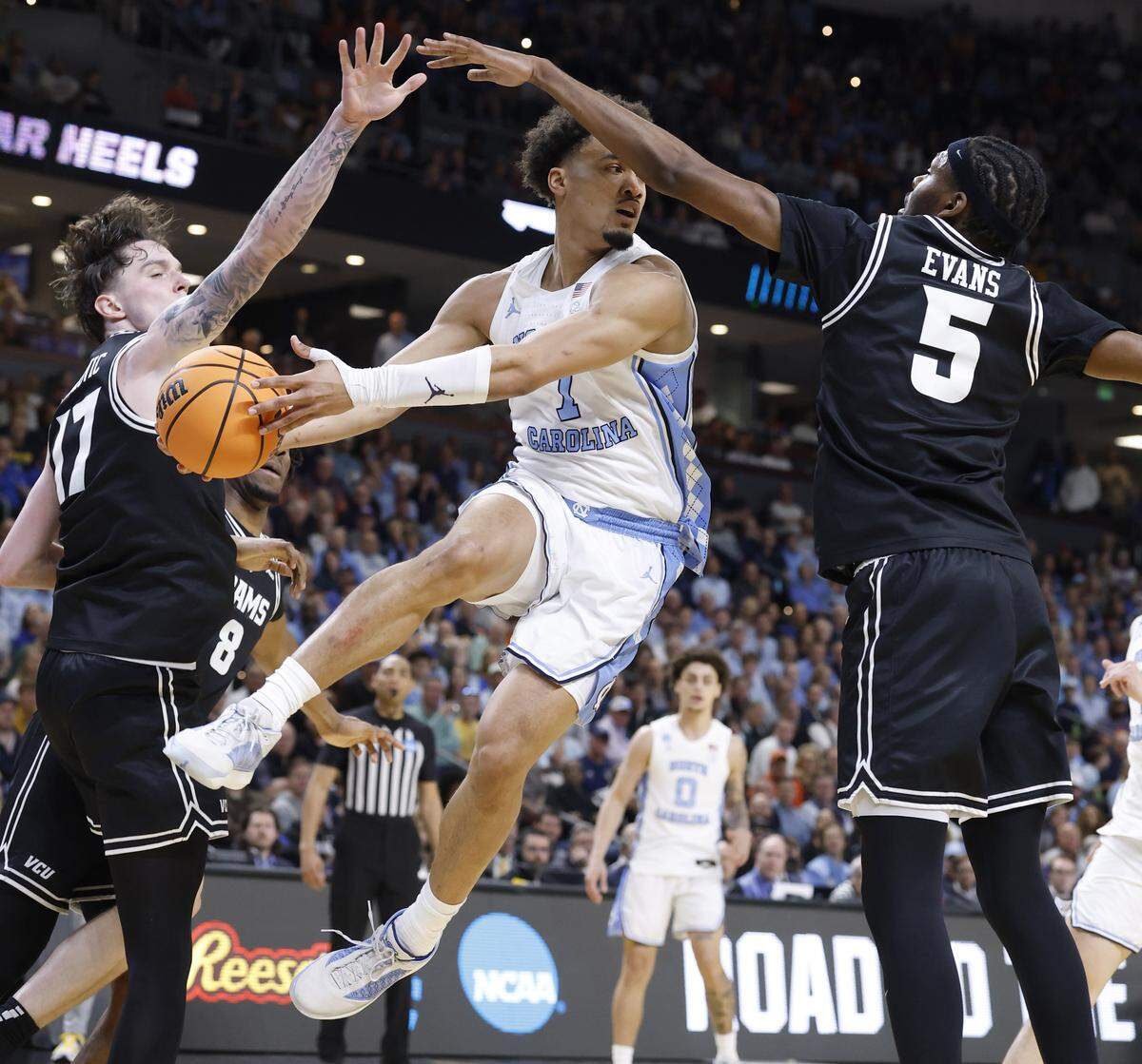 North Carolina's Seth Trimble (7) passes out of the pressure by VCU’s Lazar Djokovic (17) and Barry Evans (5) during the first half of UNC’s game against VCU in the first round of the NCAA Men’s Basketball Tournament at  Bon Secours Wellness Arena in Greenville, S.C., Thursday, March 19, 2026.