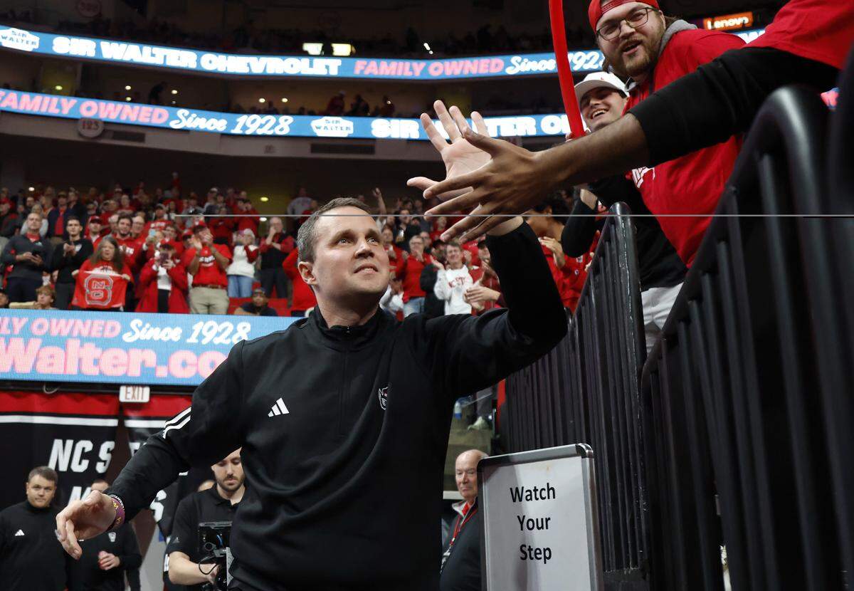 N.C. State head coach Will Wade greets the fans as he comes onto the court before N.C. State’s game against N.C. Central University at the Lenovo Center in Raleigh, N.C., Monday, Nov. 3, 2025.