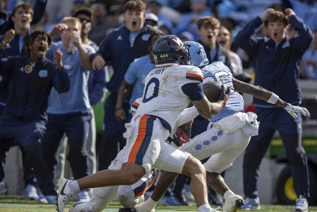 Virginia safety Antonio Clary (0) intercepts the ball forcing overtime, after North Carolina wide receiver Madrid Tucker (86) was unable to maintain control of the ball on the Tar Heels’ final play of the fourth quarter on Saturday, October 25, 2025 at Kenan Stadium in Chapel Hill, N.C.